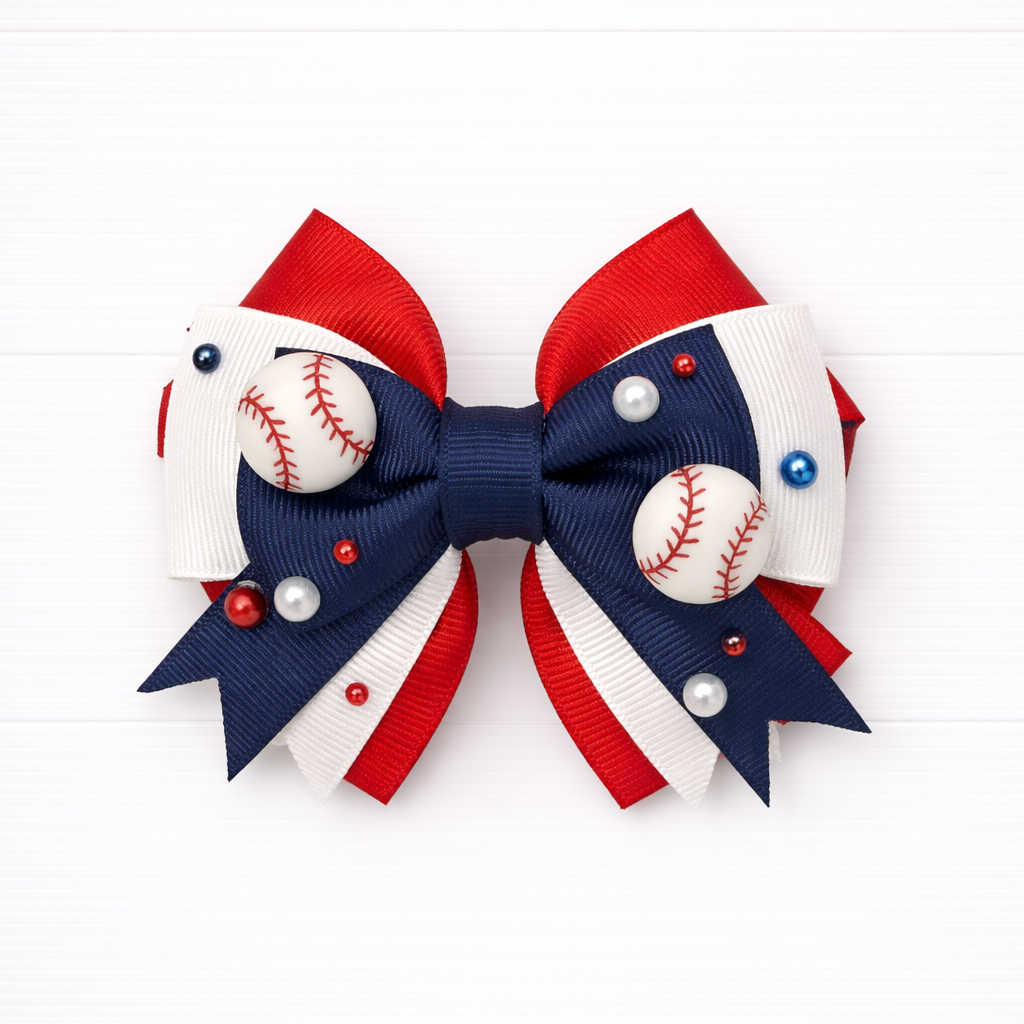 Kids girls red white and navy hair bow with baseball charms on a white background
