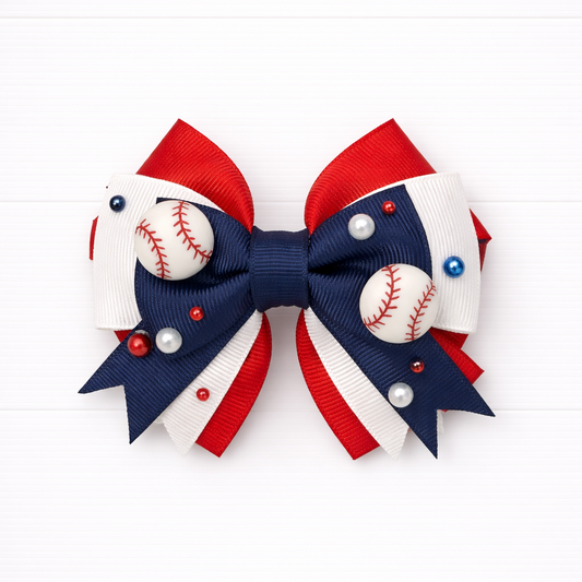 Kids girls red white and navy hair bow with baseball charms on a white background