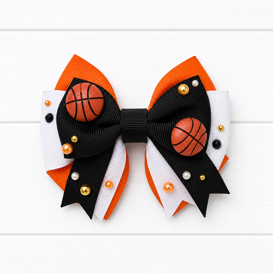 Kids orange, white, and black layered hair bow with basketball charms and gold, orange, and black pearl embellishments