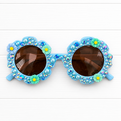 Kids blue flower Sunglasses with floral charms and embellishments on a white background