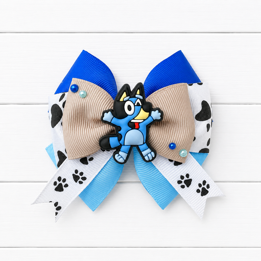 Girls royal blue and light blue hair bow with paw print ribbon and a Bluey charm in the middle