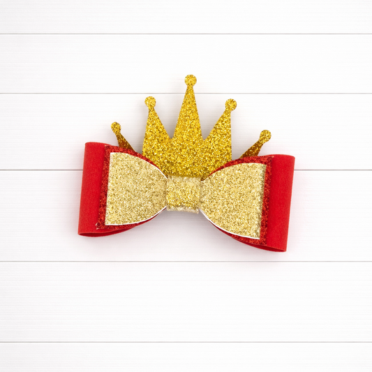 Hair bow with gold glitter crown and red base on a white background
