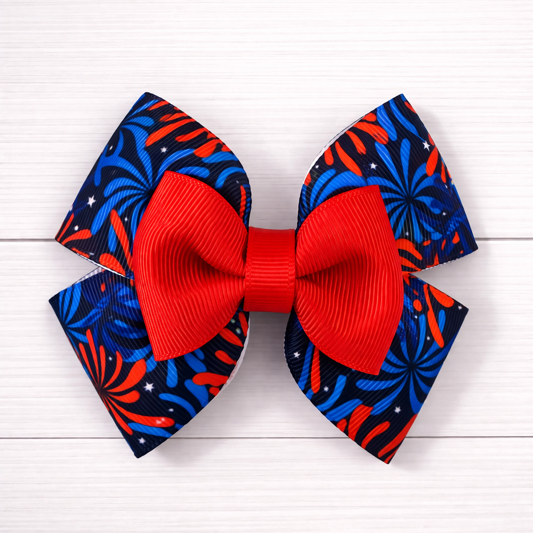 Red white and blue fireworks pattern bow behind and red bow in the front.