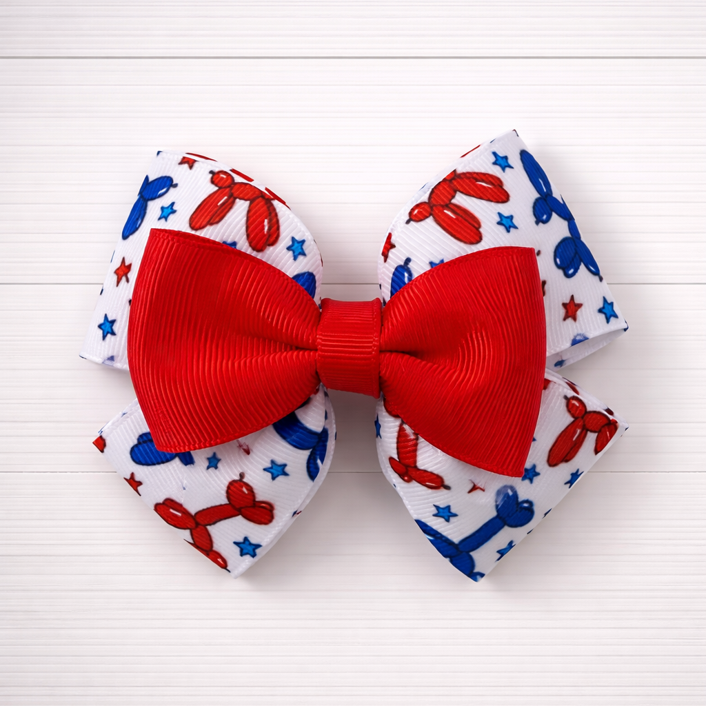Red and blue balloon dog pattern bow behind and red bow in the front