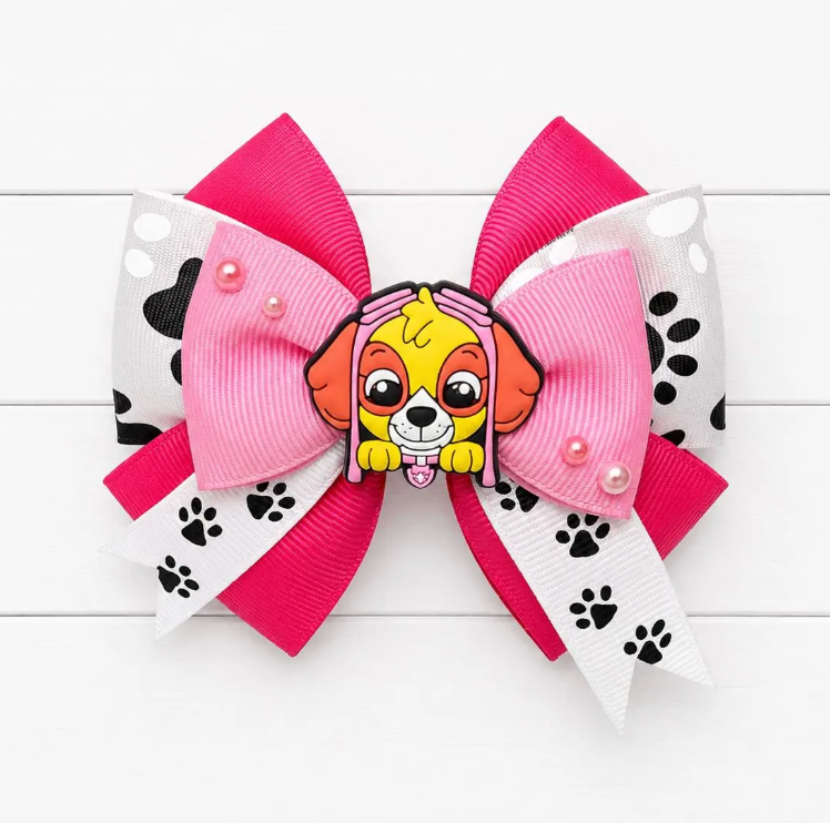 Pink Hair bow with paw print bow in the middle layer with Skye charm in the middle
