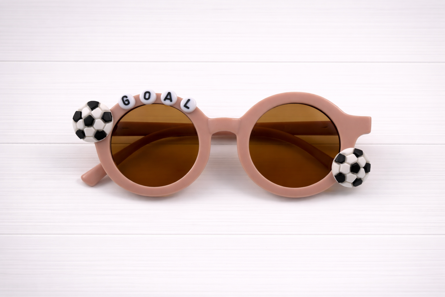 Kids grey sunglasses with two soccer charms and "GOAL" text outlining frame