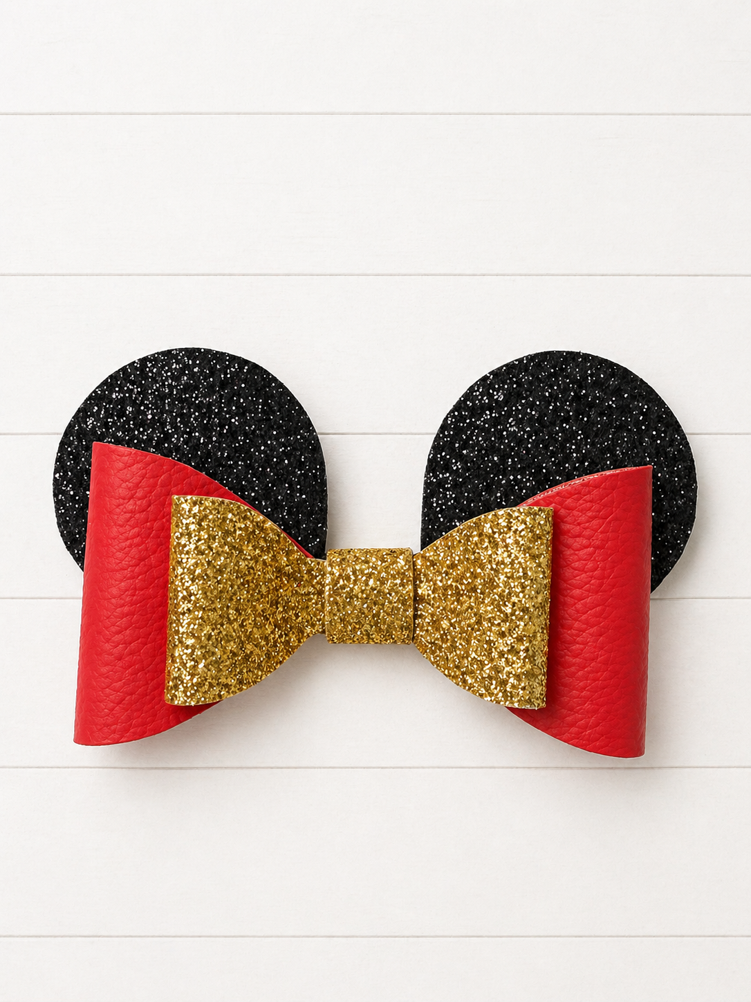 Black and red mouse ears with a gold bow on a white background