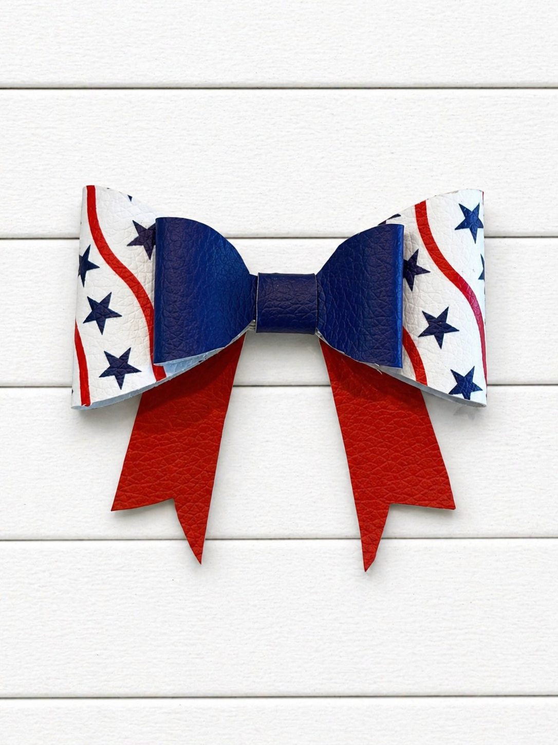 Bow with red, white, and blue pattern on a wooden background