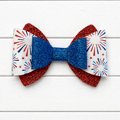 Red and blue glitter bows with fireworks design in the middle 