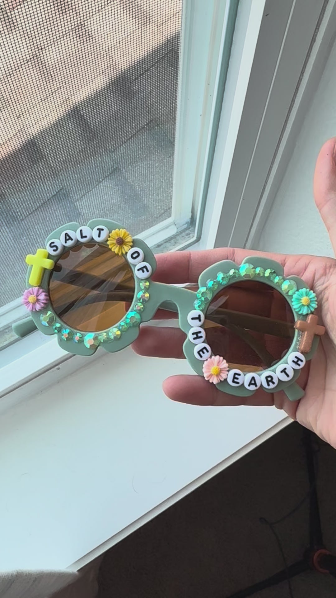 Video of Salt of the Earth sunglasses next to window for natural light