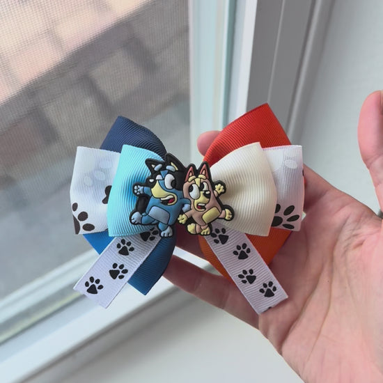 Video of sister pup bow next to window for natural light