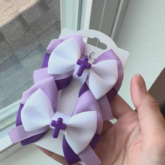 Video showing Purple Blessing Pigtail bows next to window in natural light