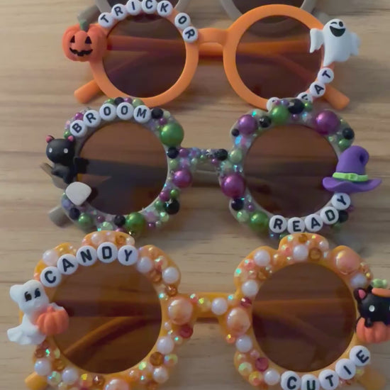 Video of all spooky crew sunglasses on a wood background