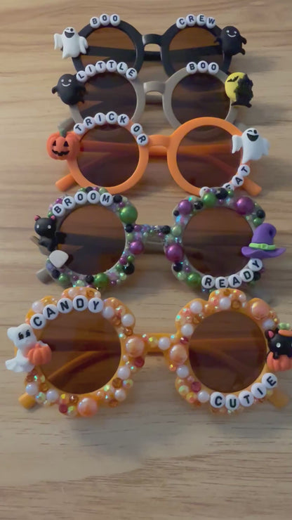 Video of all spooky crew sunglasses on a wood background