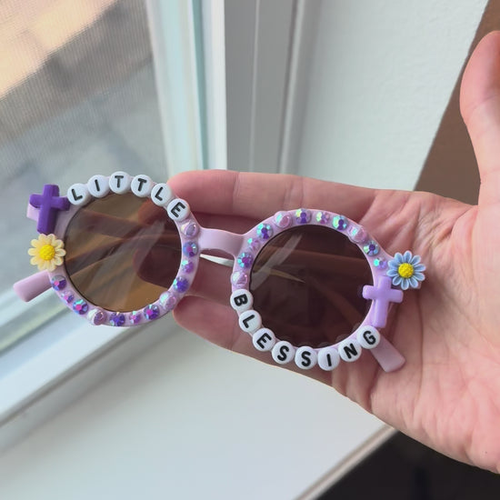 Video of little blessings sunglasses next to window for natural light