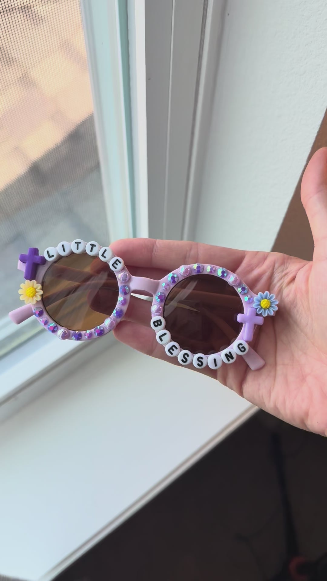 Video of little blessings sunglasses next to window for natural light